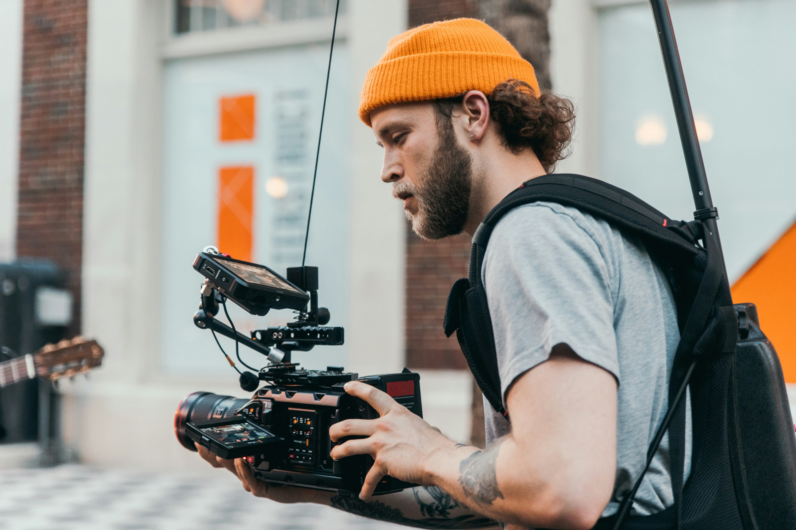 man in gray crew neck t-shirt using black video camera